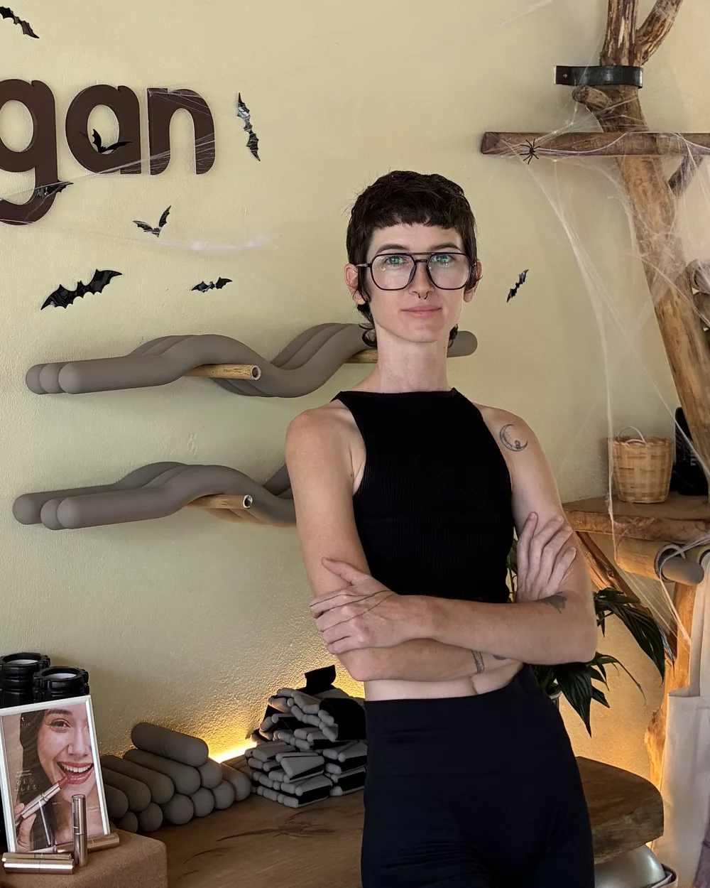 Em, arms crossed, standing in the Phangan Pilates studio reception.